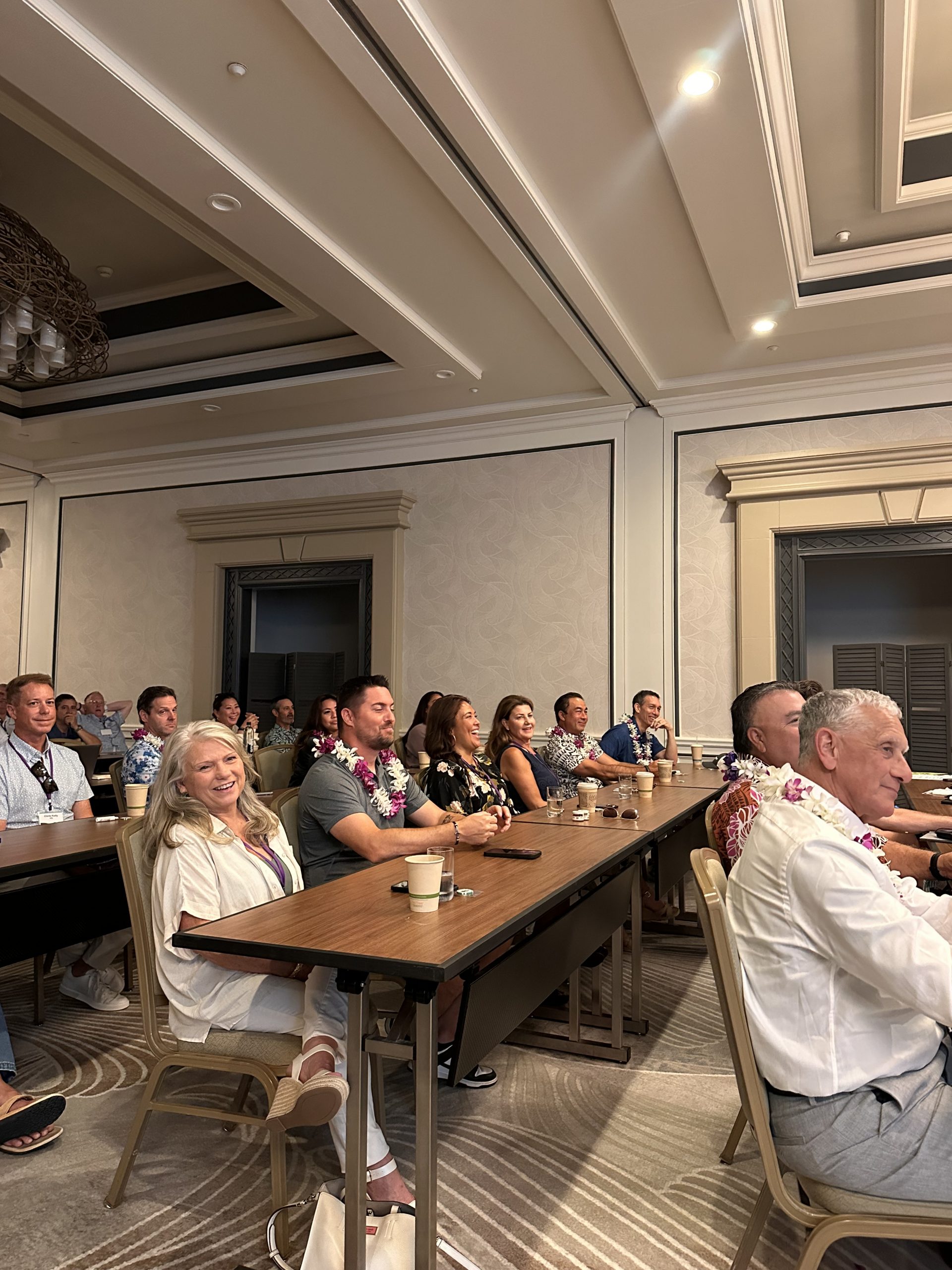 Audience members smile during the HADA Convention General Meeting